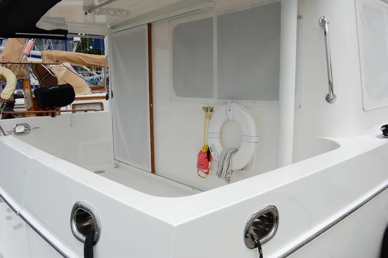 Wandering Bear Yacht Photos Pics 2001 Ocean Alexander Classico yacht deck with safety equipment and sleek design.