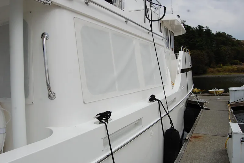 Wandering Bear Yacht Photos Pics 2001 Ocean Alexander Classico yacht docked at marina, side view with white exterior.