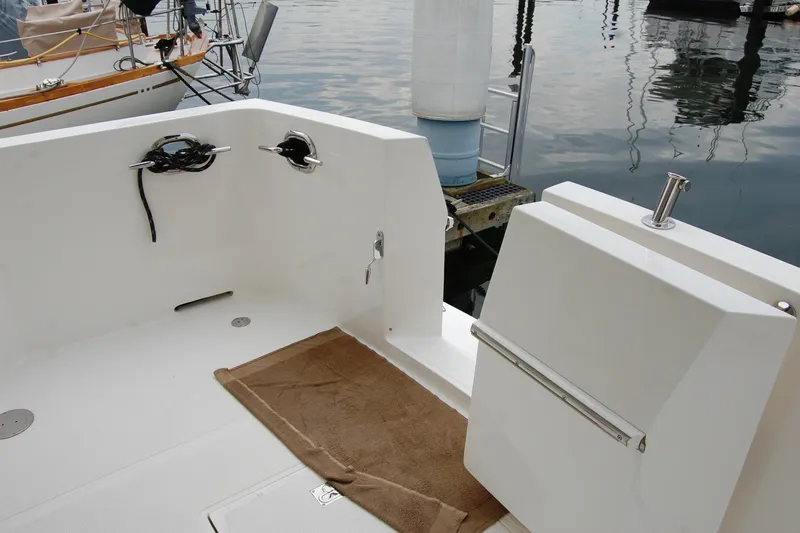 Wandering Bear Yacht Photos Pics 2001 Ocean Alexander Classico yacht deck with mooring cleats and water reflections.