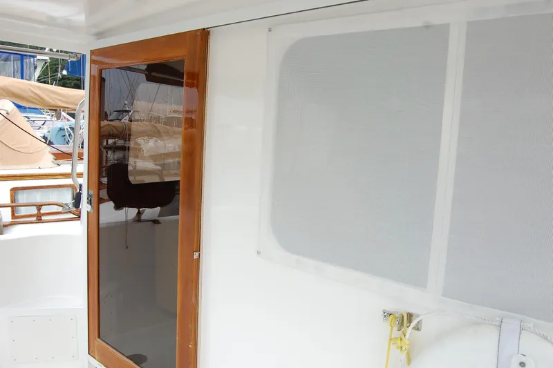 Wandering Bear Yacht Photos Pics 2001 Ocean Alexander Classico yacht with wooden door and white exterior.