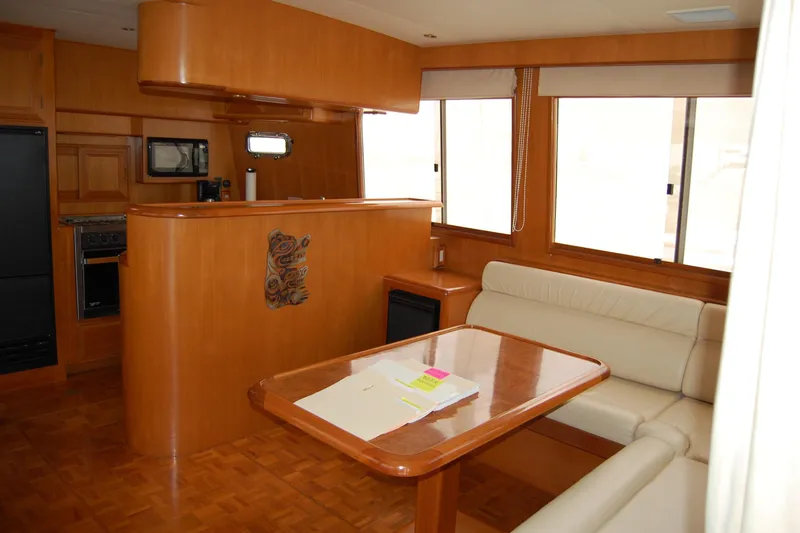 Wandering Bear Yacht Photos Pics Luxurious interior of 2001 Ocean Alexander Classico yacht with wood finish and seating area.