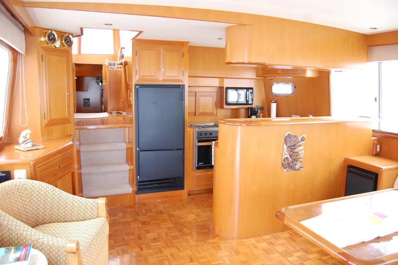 Wandering Bear Yacht Photos Pics Interior of 2001 Ocean Alexander Classico yacht with wooden cabinetry and modern kitchen amenities.