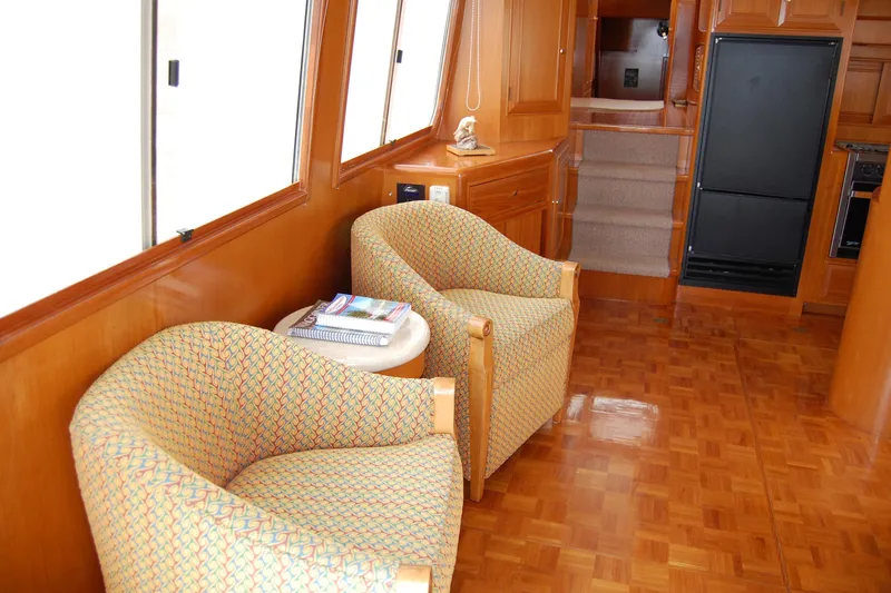 Wandering Bear Yacht Photos Pics Interior of 2001 Ocean Alexander Classico yacht with cozy seating and wooden finishes.