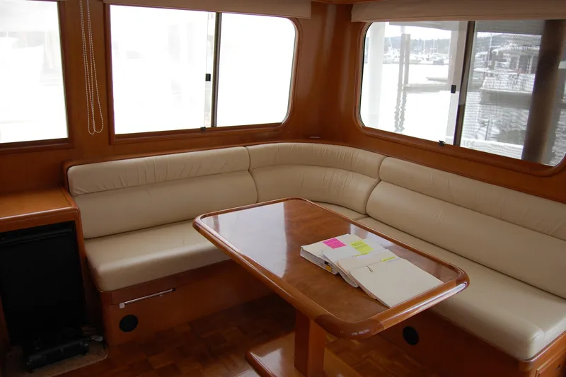 Wandering Bear Yacht Photos Pics Luxurious interior of 2001 Ocean Alexander Classico yacht with leather seating and wooden table.
