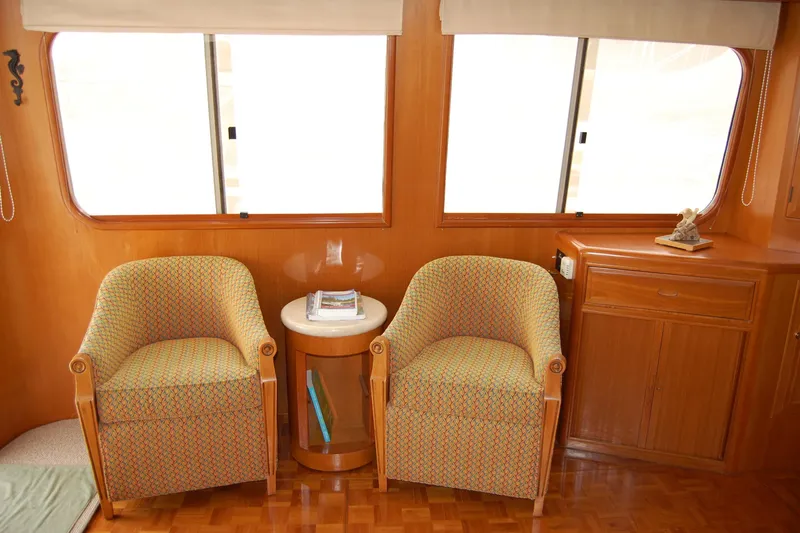 Wandering Bear Yacht Photos Pics Interior of 2001 Ocean Alexander Classico yacht with two armchairs and a side table.