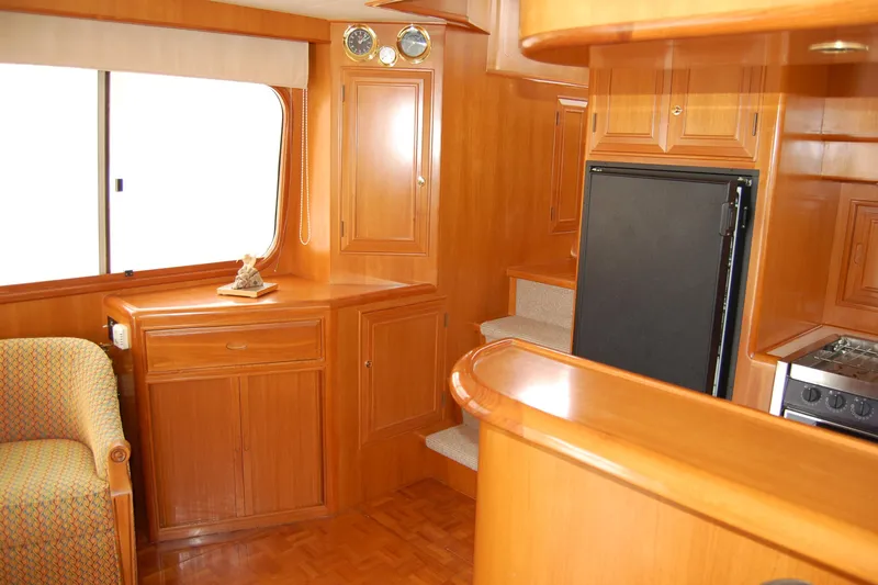 Wandering Bear Yacht Photos Pics Interior of 2001 Ocean Alexander Classico yacht with wooden cabinetry and modern appliances.
