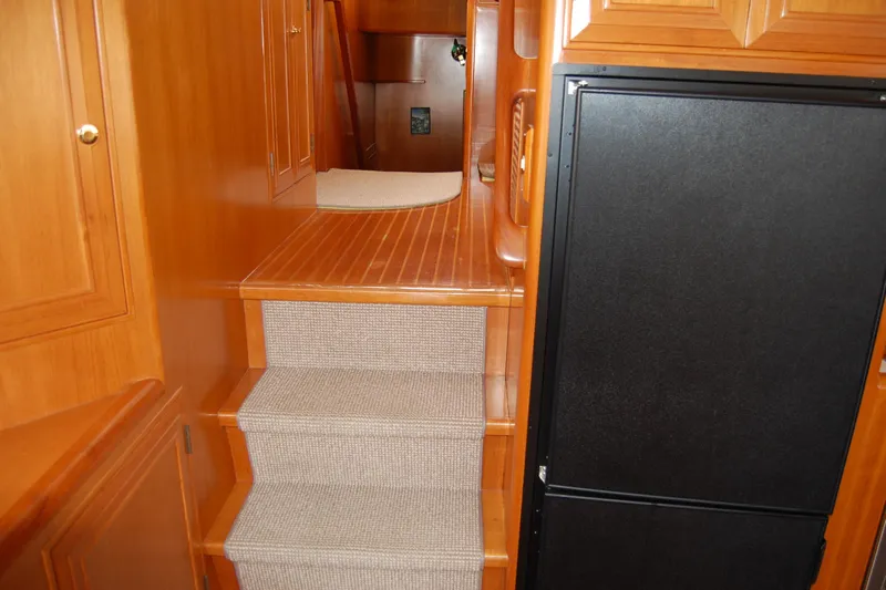 Wandering Bear Yacht Photos Pics Interior of 2001 Ocean Alexander Classico yacht with wooden stairs and cabinetry.