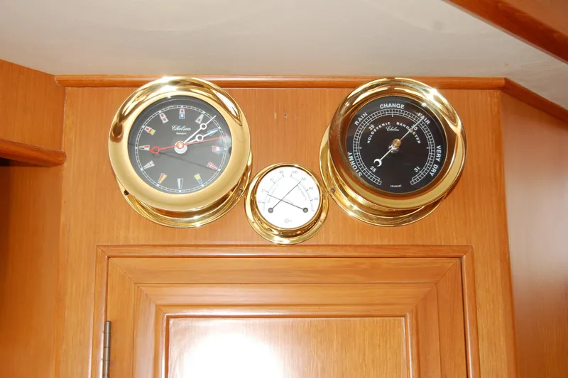 Wandering Bear Yacht Photos Pics Gold nautical instruments on Ocean Alexander Classico 2001 yacht interior.
