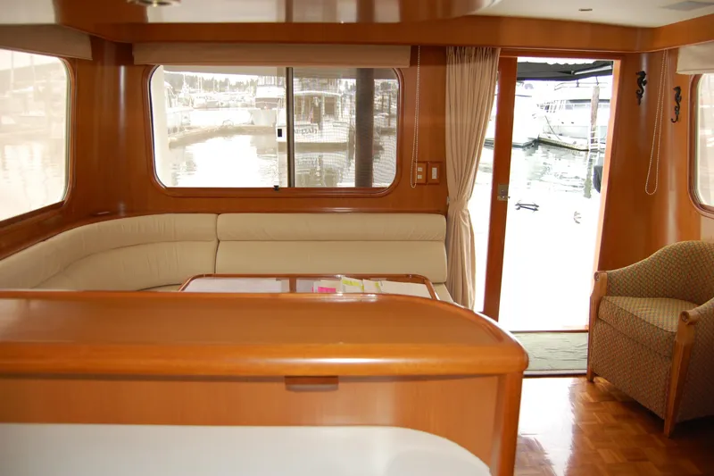 Wandering Bear Yacht Photos Pics Luxurious interior of 2001 Ocean Alexander Classico yacht with elegant wood finishes and marina view.