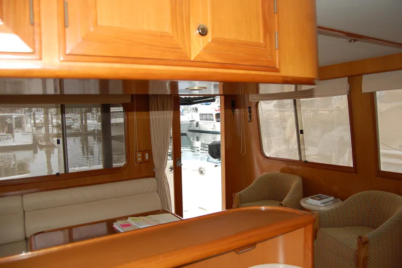 Wandering Bear Yacht Photos Pics Interior of 2001 Ocean Alexander Classico yacht with wooden cabinetry and marina view.
