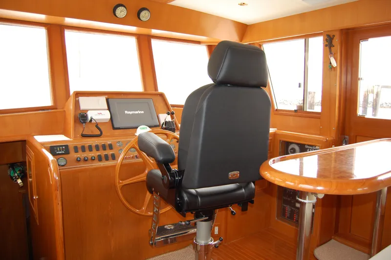 Wandering Bear Yacht Photos Pics Pilothouse of 2001 Ocean Alexander Classico yacht with steering wheel and navigation equipment.