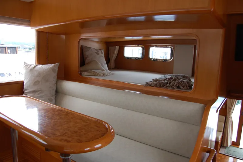 Wandering Bear Yacht Photos Pics Luxurious interior of 2001 Ocean Alexander Classico yacht with elegant wood finish and cozy seating.