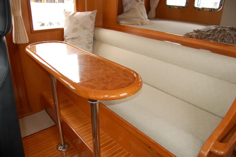Wandering Bear Yacht Photos Pics Luxurious interior of 2001 Ocean Alexander Classico yacht with elegant wood and plush seating.