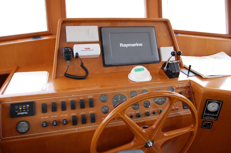 Wandering Bear Yacht Photos Pics 2001 Ocean Alexander Classico helm with Raymarine display and navigation controls.