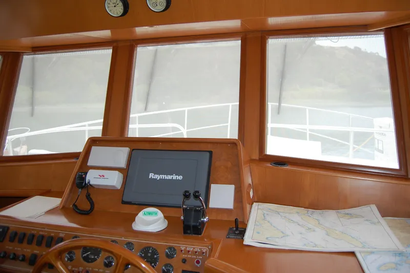 Wandering Bear Yacht Photos Pics Pilothouse of 2001 Ocean Alexander Classico yacht with navigation equipment and sea charts.
