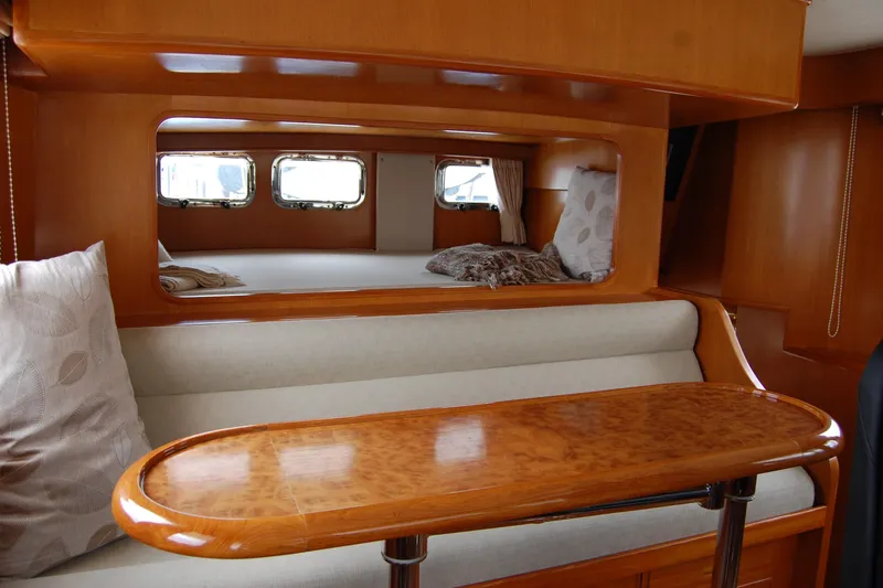 Wandering Bear Yacht Photos Pics 2001 Ocean Alexander Classico yacht interior with wooden table and cozy seating area.