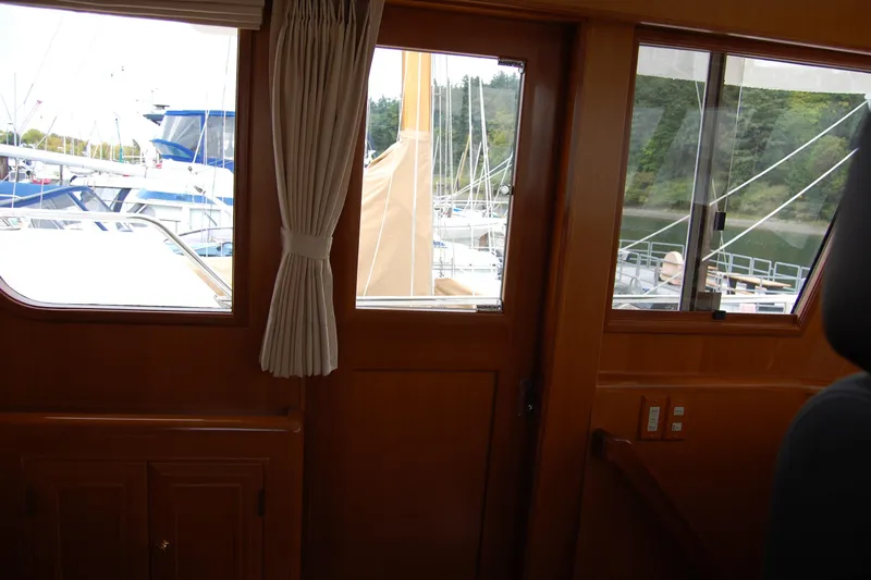 Wandering Bear Yacht Photos Pics Interior view of 2001 Ocean Alexander Classico yacht with marina backdrop.