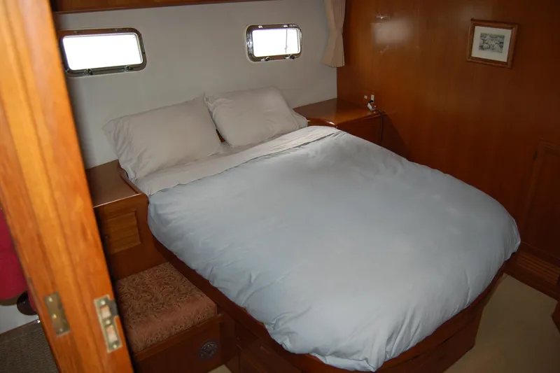 Wandering Bear Yacht Photos Pics Cozy bedroom in 2001 Ocean Alexander Classico yacht with wooden interior and double bed.