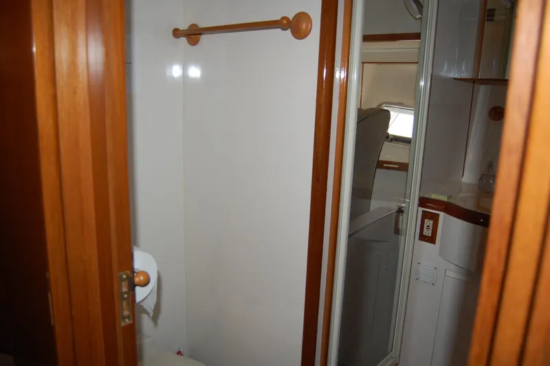 Wandering Bear Yacht Photos Pics Interior of 2001 Ocean Alexander Classico yacht bathroom with wooden accents and mirror.
