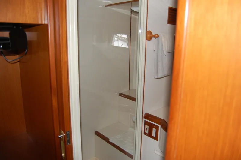 Wandering Bear Yacht Photos Pics Interior of 2001 Ocean Alexander Classico yacht bathroom with wooden accents.