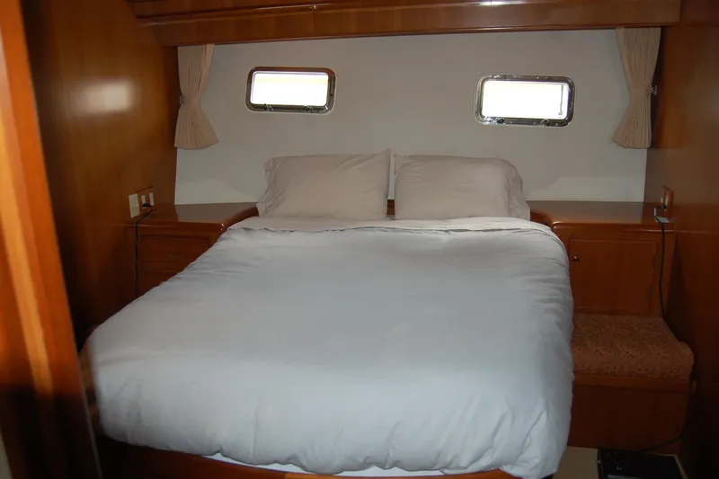 Wandering Bear Yacht Photos Pics Luxurious bedroom interior of 2001 Ocean Alexander Classico yacht with cozy bedding.