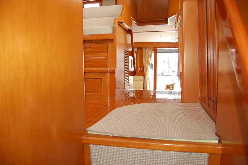 Wandering Bear Yacht Photos Pics Interior of 2001 Ocean Alexander Classico yacht with polished wood and carpeted steps.