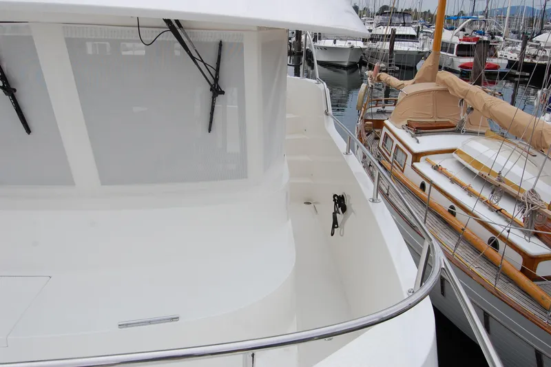 Wandering Bear Yacht Photos Pics 2001 Ocean Alexander Classico yacht docked at marina, showcasing sleek design and spacious deck.