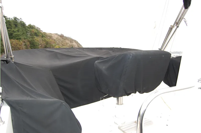 Wandering Bear Yacht Photos Pics Covered seating area on 2001 Ocean Alexander Classico yacht, near rocky shoreline.