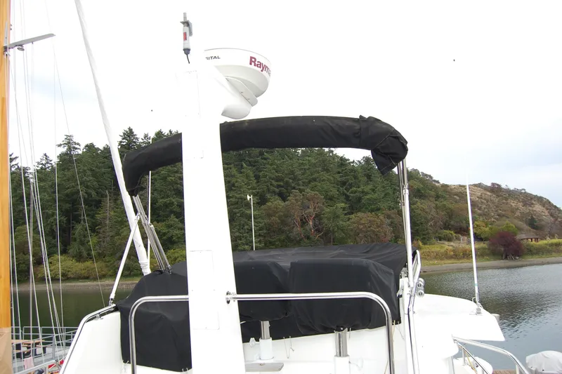 Wandering Bear Yacht Photos Pics 2001 Ocean Alexander Classico yacht with radar, docked near forested shoreline.