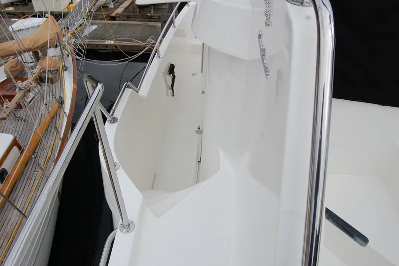 Wandering Bear Yacht Photos Pics 2001 Ocean Alexander Classico yacht deck with polished railings and clean white surface.