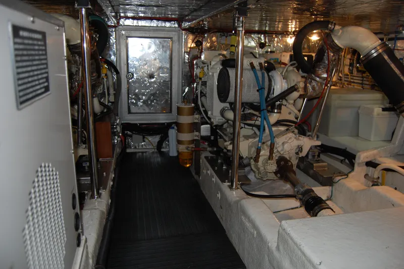 Wandering Bear Yacht Photos Pics Engine room of 2001 Ocean Alexander Classico yacht, showcasing mechanical components and equipment.