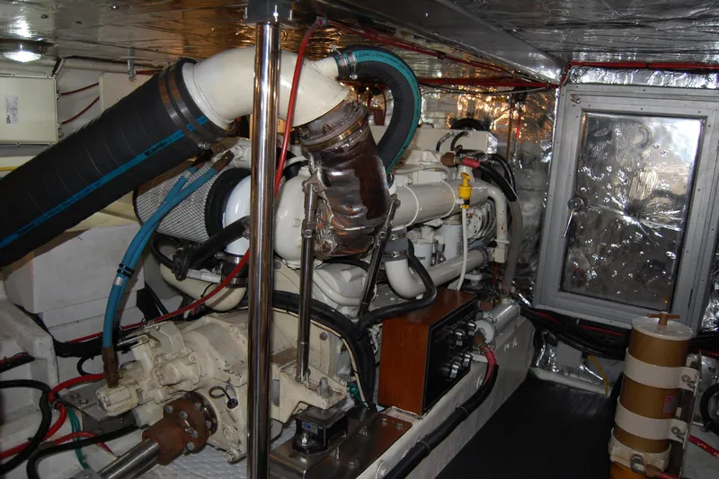 Wandering Bear Yacht Photos Pics Engine room of 2001 Ocean Alexander Classico yacht, showcasing mechanical components and piping.