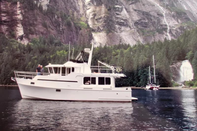 Wandering Bear Yacht Photos Pics Ocean Alexander Classico 2001 yacht in scenic mountain and waterfall backdrop.