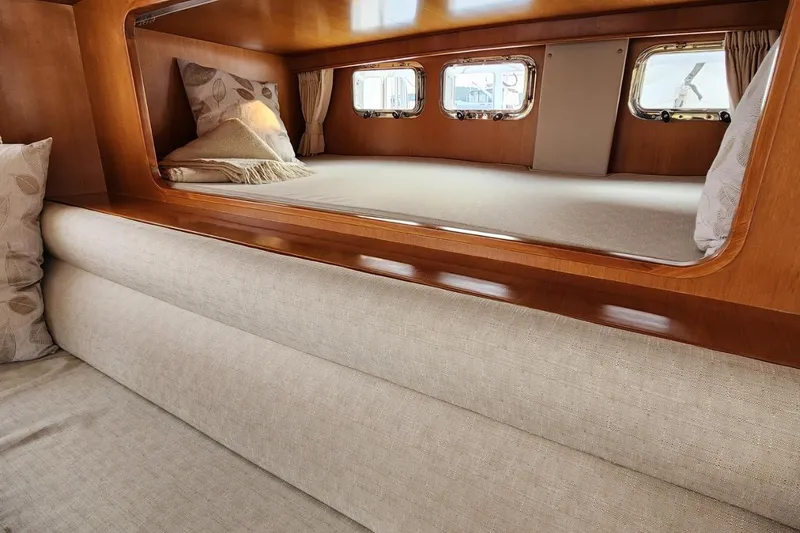 Wandering Bear Yacht Photos Pics Luxurious cabin interior of 2001 Ocean Alexander Classico yacht with cozy bedding.