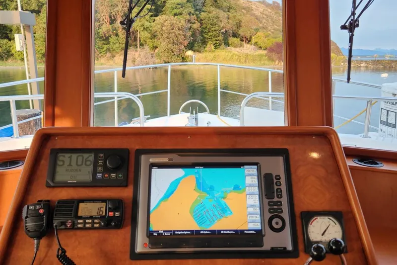 Wandering Bear Yacht Photos Pics Cockpit view of 2001 Ocean Alexander Classico yacht with navigation equipment and scenic waterway.