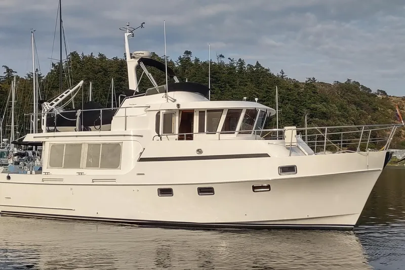 Wandering Bear Yacht Photos Pics 2001 Ocean Alexander Classico yacht docked in a serene marina setting.