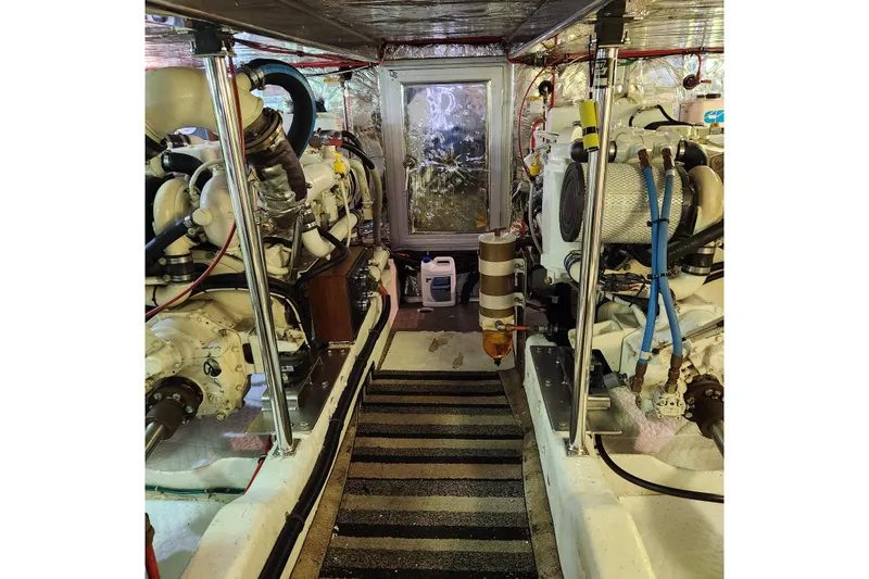 Wandering Bear Yacht Photos Pics Engine room of 2001 Ocean Alexander Classico yacht, showcasing dual engines and mechanical components.