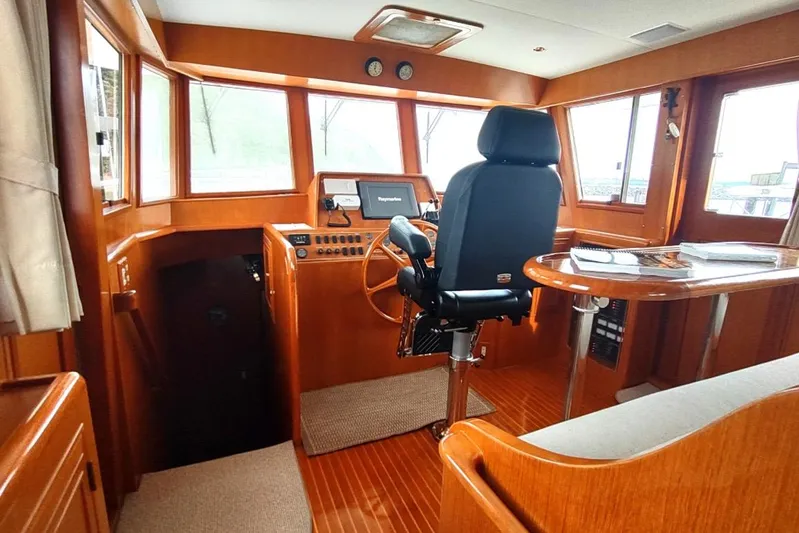 Wandering Bear Yacht Photos Pics Pilothouse of 2001 Ocean Alexander Classico yacht with wooden interior and navigation equipment.