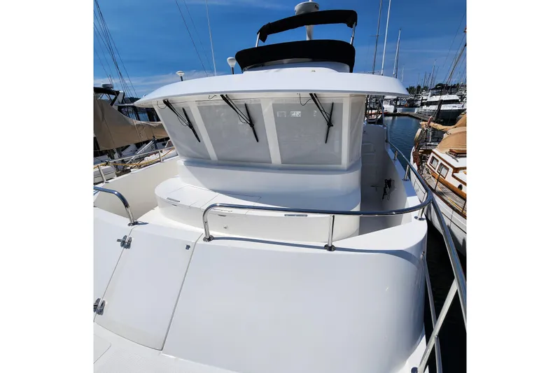 Wandering Bear Yacht Photos Pics 2001 Ocean Alexander Classico yacht docked at marina, showcasing sleek design and spacious deck.