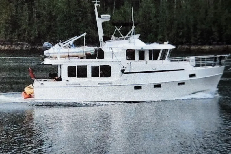 Wandering Bear Yacht Photos Pics Ocean Alexander Classico 2001 yacht cruising on a calm waterway with forested background.