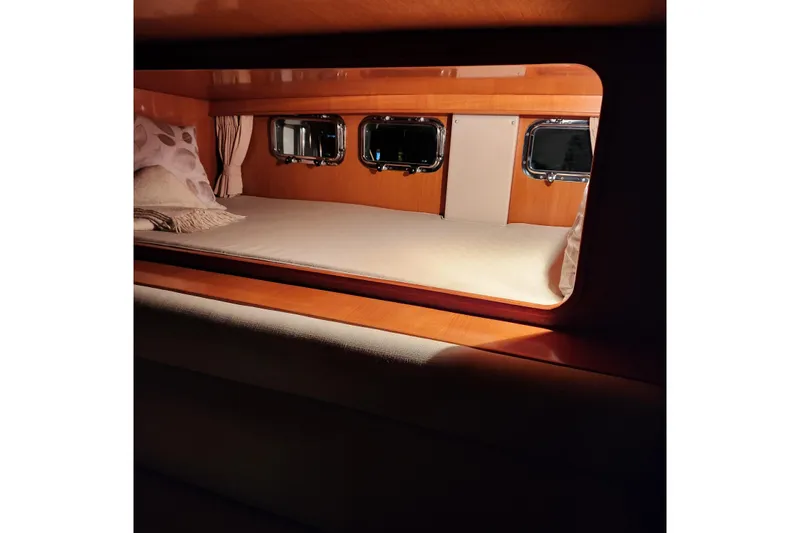Wandering Bear Yacht Photos Pics Cozy cabin interior of 2001 Ocean Alexander Classico yacht with porthole windows.