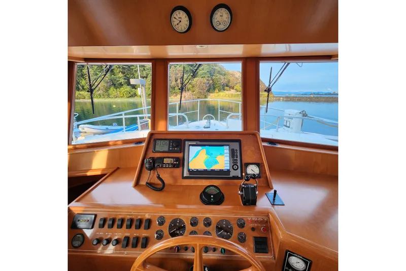 Wandering Bear Yacht Photos Pics Pilothouse of 2001 Ocean Alexander Classico yacht with navigation equipment and scenic view.