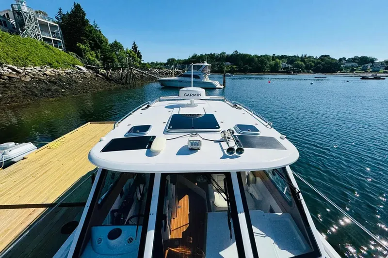 Forever Moor Yacht Photos Pics 2024 True North 34 Outboard Express docked in scenic marina setting.