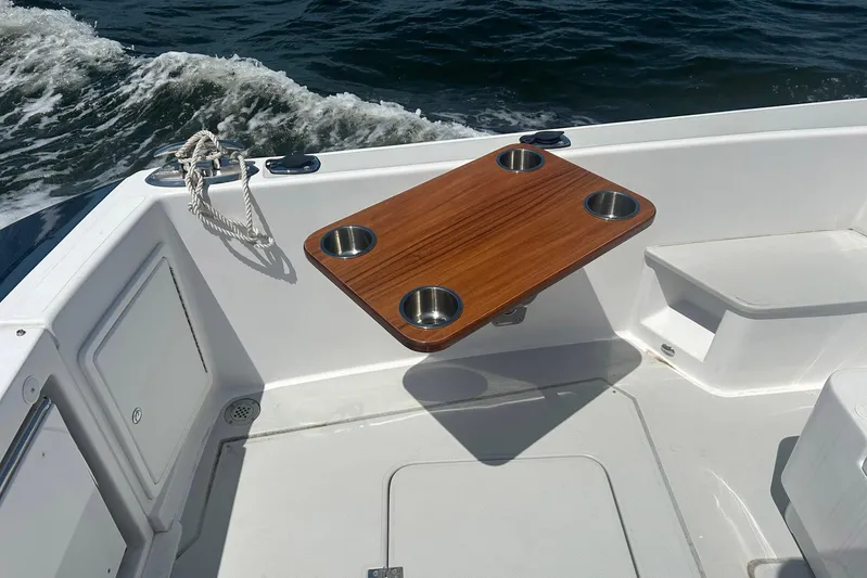 Forever Moor Yacht Photos Pics 2024 True North 34 Outboard Express boat interior with wooden table and cup holders.