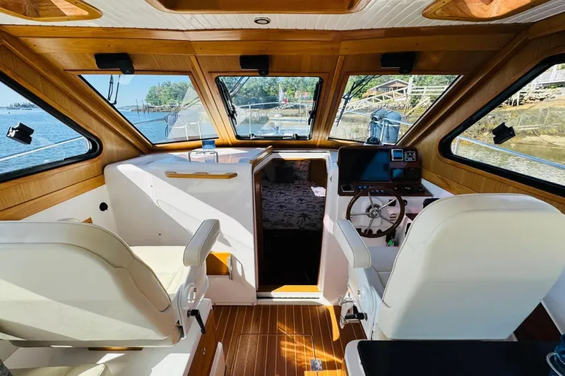Forever Moor Yacht Photos Pics 2024 True North 34 Outboard Express interior with wood accents and modern helm.