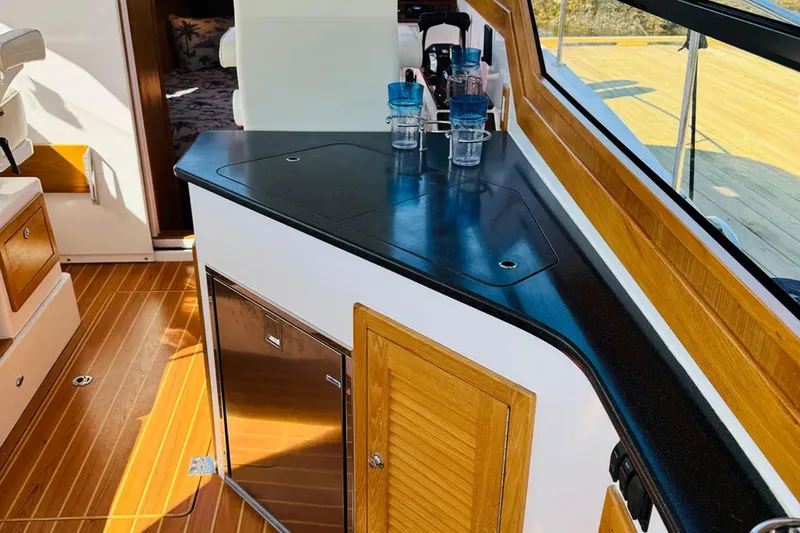 Forever Moor Yacht Photos Pics 2024 True North 34 Outboard Express interior with wood accents and countertop.