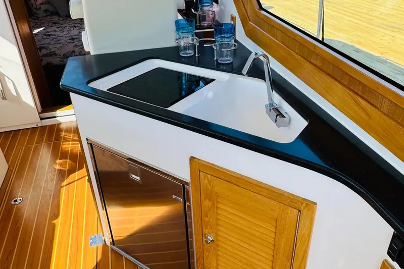 Forever Moor Yacht Photos Pics 2024 True North 34 Outboard Express interior with sleek kitchenette and modern fixtures.