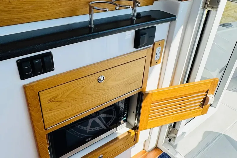 Forever Moor Yacht Photos Pics 2024 True North 34 Outboard Express interior with wooden cabinetry and modern appliances.