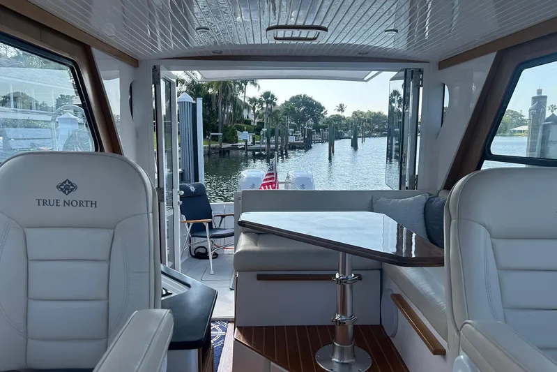 Forever Moor Yacht Photos Pics Interior view of 2024 True North 34 Outboard Express yacht with open water backdrop.