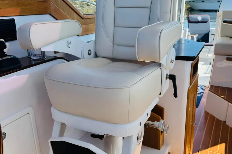 Forever Moor Yacht Photos Pics Luxurious captain's chair on 2024 True North 34 Outboard Express boat interior.